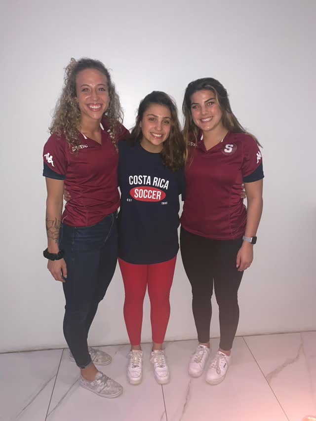 Annie Williams and Katie Pingel in Saprissa jerseys with 15-year-old Sophie Castro in Costa Rica